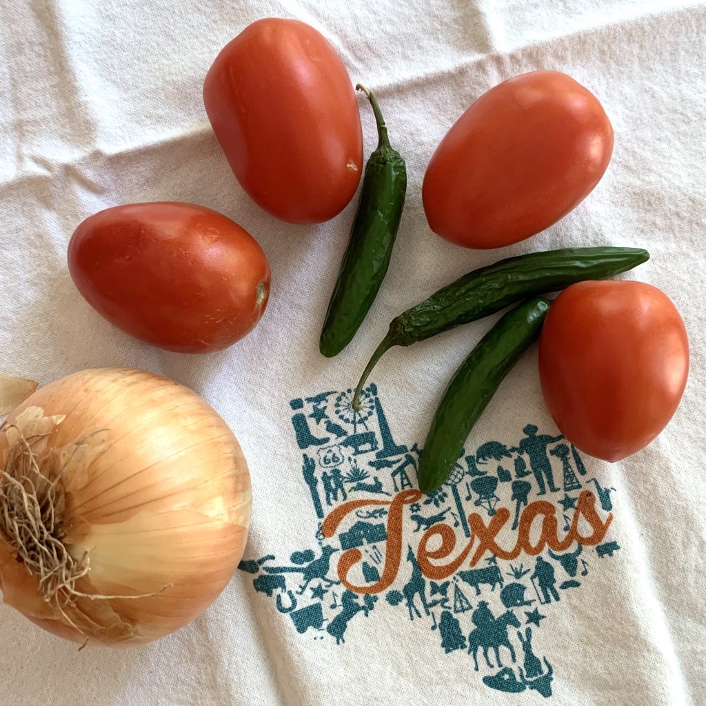 tomatoes, jalapenos, and onion on dish towel with texas graphic