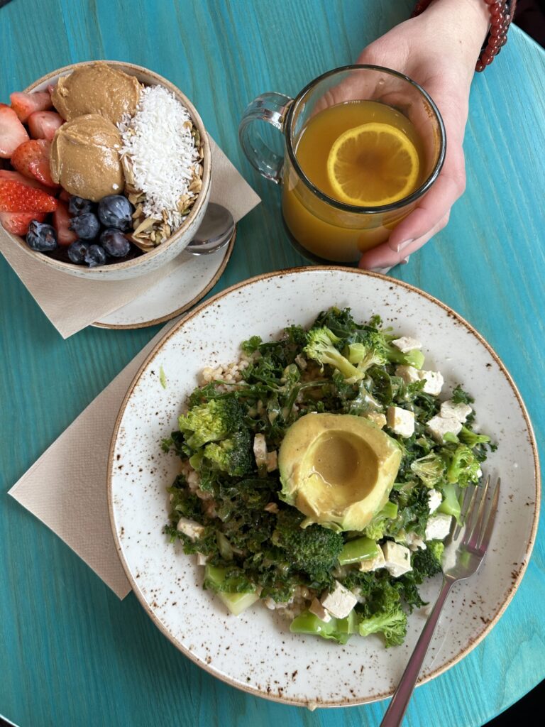 healthy lunch green salad and acai bowl with mug of tea